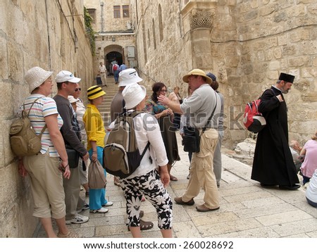 JERUSALEM, ISRAEL - OCTOBER 09, 2012: Excursion group before the temple of the Lord\'s Coffin on the Mount Golgotha in Jerusalem