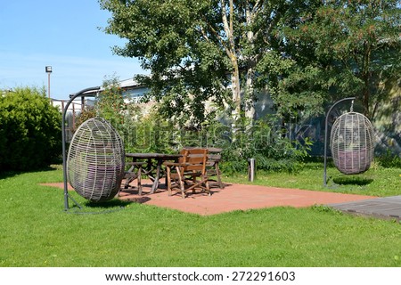 Hanging chair and wooden garden furniture in the territory of the center of rest, Kaliningrad