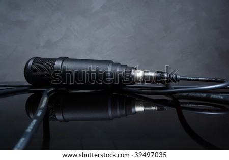 black microphone cable on the glass