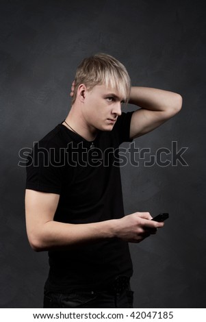 young blond guy with a gray background