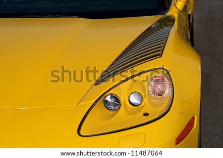 front of bright yellow performance car headlights