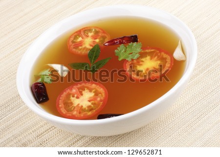 Rasam ,A South Indian soup, traditionally prepared using tamarind juice as a base eaten with rice or separately as soup.Rasam has a distinct taste in  and is usually fluid in consistency.