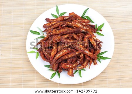 Top view of Anchovy fish fry with curry leaves,Anchovies serves as a excellent source of calcium, proteins, vitamins, and omega-3 fatty acids,
