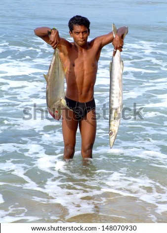 VARKALA,INDIA-January-18: Lucky fisherman holding fish in Varkala beach,is the only place in southern Kerala where cliffs are found adjacent to the Arabian Sea. January18 ,2005,VARKALA,INDIA .