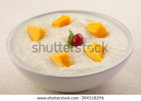 Organic  rice pudding  with yellow mango and coconut.