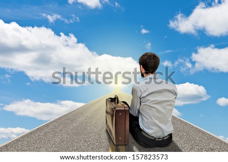 Young businessman sitting and looking far on the road of future