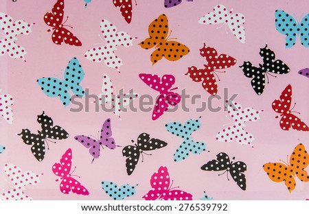 Pink background with butterflies in red, purple, black, white, inside of butterflies there are dots. Much loved by girls.