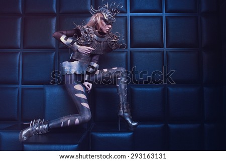 Woman in steel costume and head wear