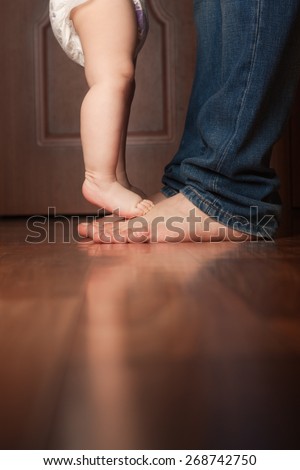 Similar – Image, Stock Photo Baby reaching for feet, dimpled baby hands, triangle print blanket and pants