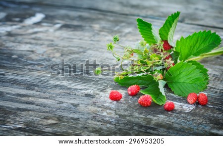 bouquet of strawberries on the board. Summer berries collected in the forest. Rural texture . Greeting Card fashion