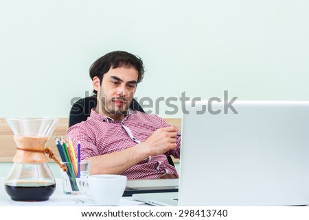 Natural sloppy image of the modern businessman or designer . toned photo. Workplace Designer