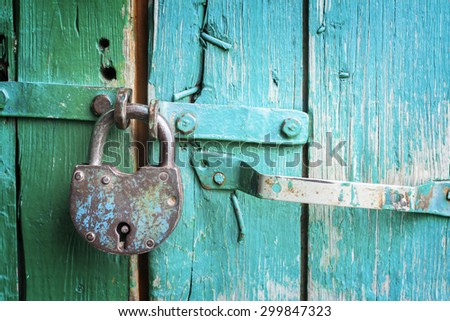 Old lock on the door. lock on the door of an old farmhouse . true village style . close-up. focus on lock