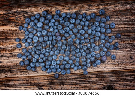 blueberries sprinkled . textured board . natural eco-friendly product . healthy food and vitamins. rural style . view from above