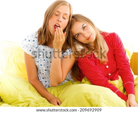 sleepy girlfriends in bed after a pajama party.