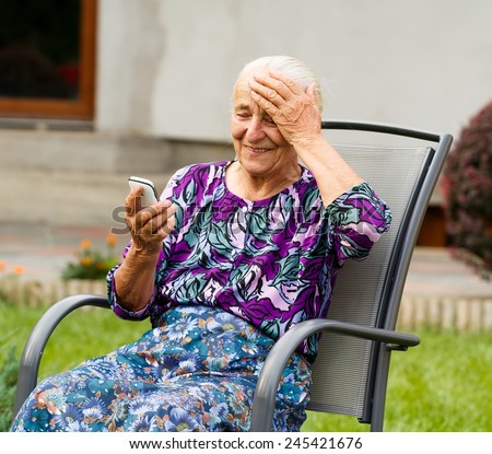 Funny grandmother confused with using smartphone.