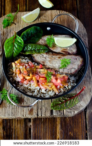 Baked meat with rice and tomato-peach salsa
