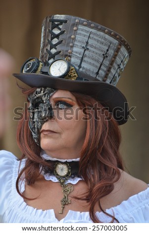 Adult steampunk woman with eyewear and hat posing at the elf fantasy fair Elfia in Arcen, Netherlands on the 20th of September 2014.