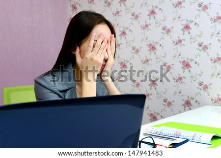 Business woman tired and stressed after hard work with laptop at