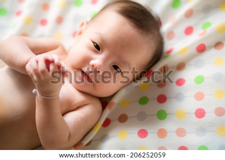 Asian baby girl with powder after bath