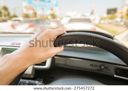 Hands on the steering wheel and driving in city