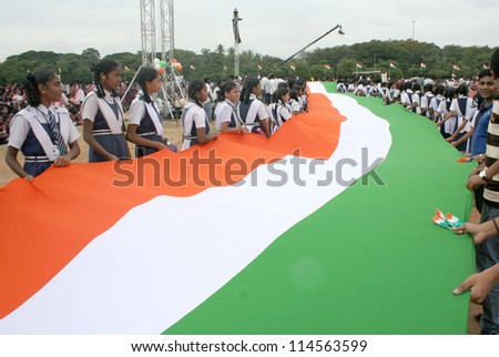 HYDERABAD,AP,INDIA-AUGUST 28:School Children assemble with long flag,  to render national anthem,to mark 100 th year of the song, in  event by NTV ar NTR ground on August 28,2012 in Hyderabad,India.