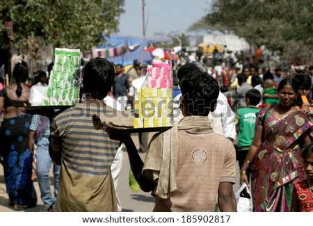 KESARAGUTTA,AP,INDIA- FEBRUARY 27: Street Vendors sell bakery food in a crowded road on February 27,2014 in Kesaragutta,Ap,India. Popular street food is available in all places in india.