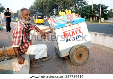 HYDERABAD,INDIA-JANUARY 6: Indian street vendor sell ice cream  on a busy road in Hyderabad,January 6,2012.