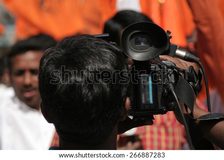 HYDERABAD,INDIA-APRIL 3:Indian TV channel videographer cover the hanuman jayanti procession,an annual event,a Hindu celebration on April 3,2015 in Hyderabad,India.