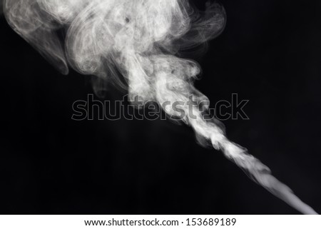 Smoke, vapor, or diffused essential oil on a black background