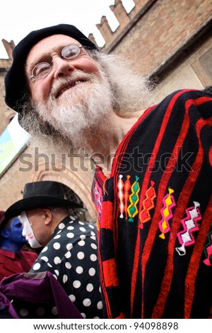 BOLOGNA, ITALY - JUN 18: An Old man masked as himself [old Hippie] is smiling having fun during the \'Partòt\' Street Parade 2011 in \'Piazza Maggiore\' Bologna, Italy on Jun 18, 2011.