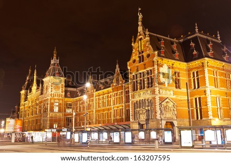 AMSTERDAM - JULY 27: Central Station by night, as seen on July 27, 2013 in Amsterdam, Netherlands. Central Station is the central railway station of Amsterdam and is used by 250,000 passengers a day.