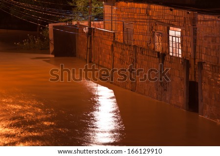 NOVA IGUACU, RIO DE JANEIRO, BRAZIL - DECEMBER 6: Poor living area flooded after heavy rain on 6th December, 2013. The water level of local river got few meters higher, many houses were flooded.