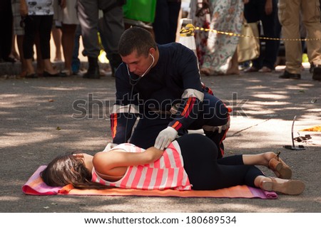 RIO DE JANEIRO, BRAZIL - FEBRUARY 1: Brazilian soap opera episode is being filmed in the street on 1 February 2014. Young woman hit by the bus is getting first medical aid.