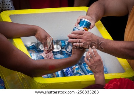 RIO DE JANEIRO, BRAZIL - FEBRUARY 14, 2015: Man selling beer in the street during Carnival. During big events street sellers make thousands of dollars within few days.