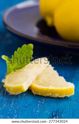 Fresh lemon with sugar on the blue wooden table