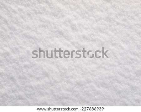 Snow background, newly-fallen white snow surface texture closeup at winter