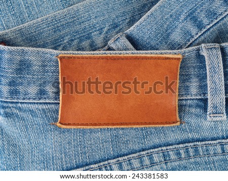 Blank leather patch sewed to old denim jeans