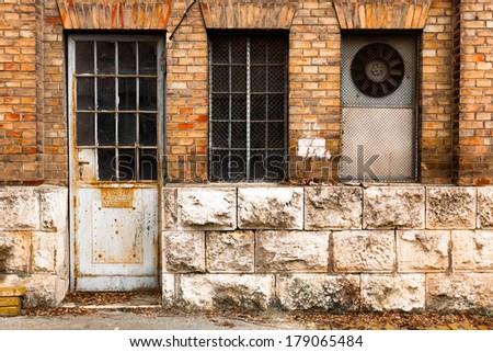 an old industrial building exterior wall, door and window