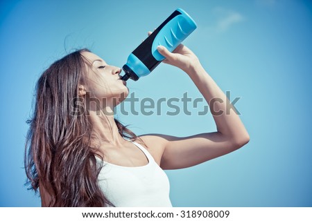 Similar – Image, Stock Photo Woman drinking isotonic drink while resting