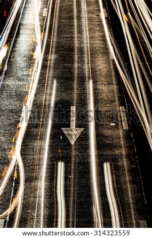 light painting on asphalt road by vehicle moving with arrow sign
