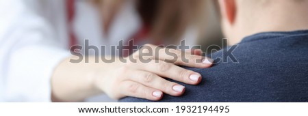 Female doctor holding shoulder of male patient closeup. Psychological support concept Photo stock © 