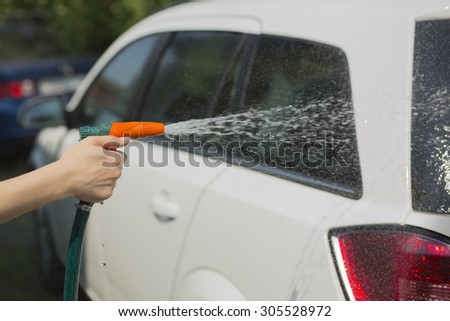 washing the car in the yard of a country house