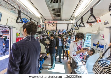 TOKYO- JULY 3: Commuters ride Tokyo metro transit system in Tokyo, Japan on July 3, 2011. The transit system carries 8.7 million passengers per day