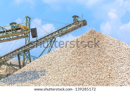 Conveyor and pile of quarry stone for lime industry