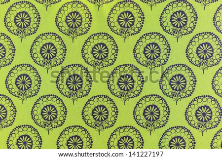 Old green wallpaper with dark blue flower pattern for texture or background