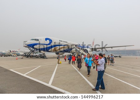BEIJING JULE 30, Passengers get off from Air Chaina at Beijing airport on June 30, 13,in Beijing. The airport has registered 488,495 annually aircraft movements and ranked 10th in the world.