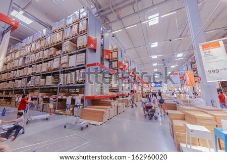BANGKOK - OCTOBER 23: People pick up furniture component from the shelf at IKEA Bangkok Store on October 23, 2013 in Bangkok. Founded in Sweden in 1943, Ikea is the world\'s largest furniture retailer.