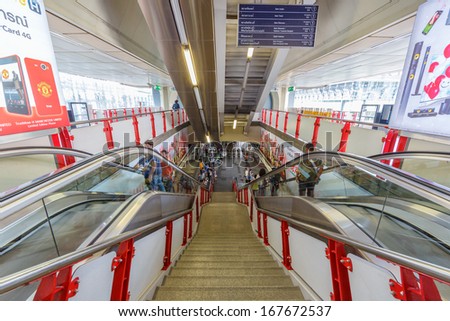 BANGKOK - DECEMBER 5: Passengers walk in BTS elevated rails in Siam Station on December 5, 2013 in Bangkok, Thailand. It\'s the first electric train system in Thailand.
