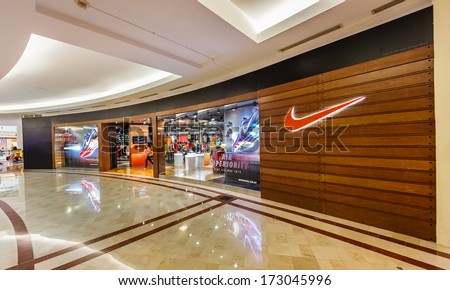 KUALA LUMPUR - DEC 23: Nike shop at KLCC on Dec 23,13 in KL. It is an American company, engaged in the design, development, manufacturing and marketing of footwear, apparel, equipment and services.
