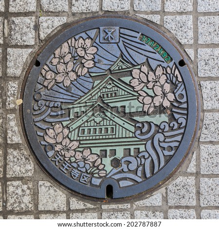 OSAKA - APR 7: Osaka Castle on manhole cover of Osaka on Apr 7, 14 in Osaka, Japan. It is a city in the Kansai region of Japan\'s main island of Honshu, a designated city under the Local Autonomy Law.